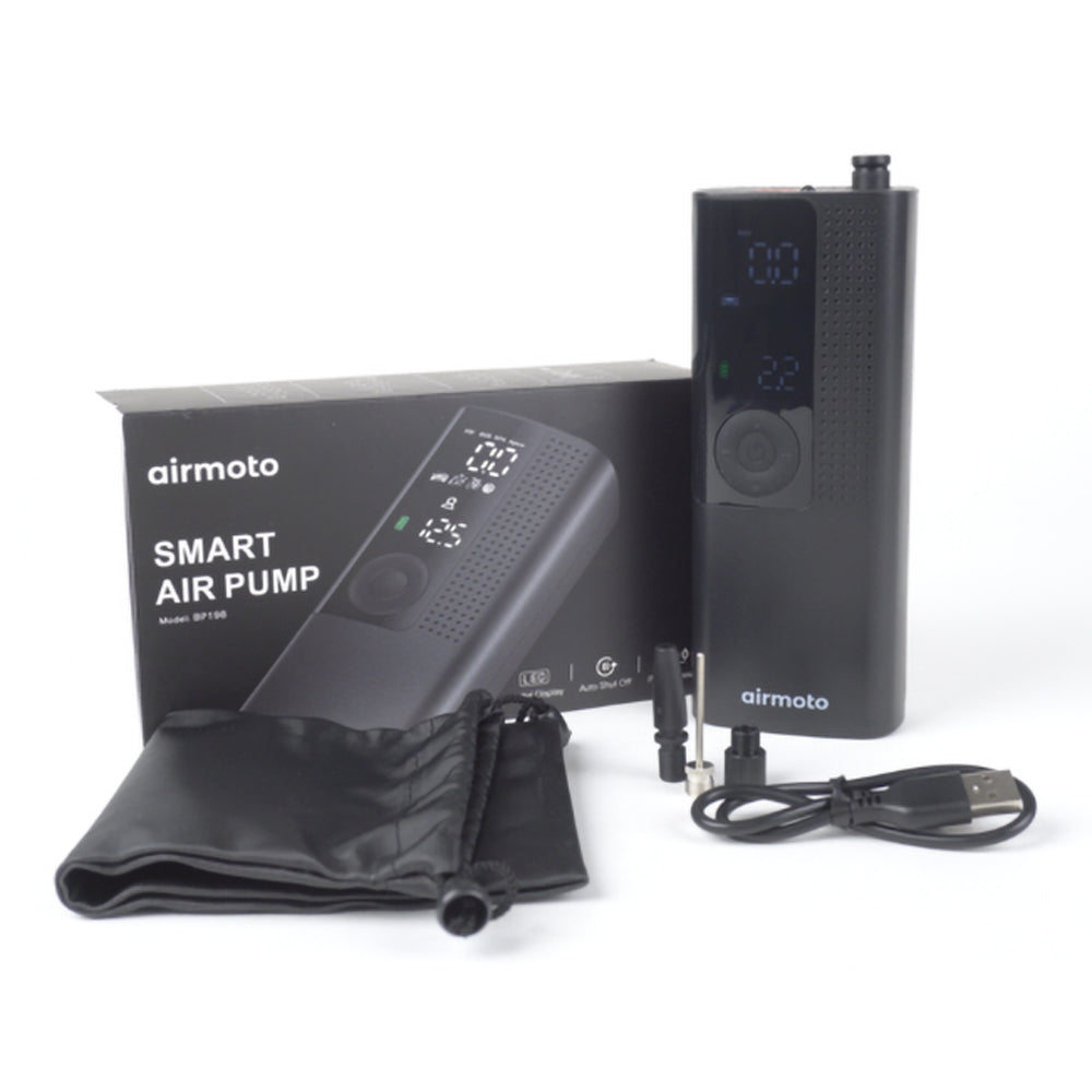 The Airmoto smart air pump shown with its retail box, carry pouch, nozzle adapters, and USB-C cable
