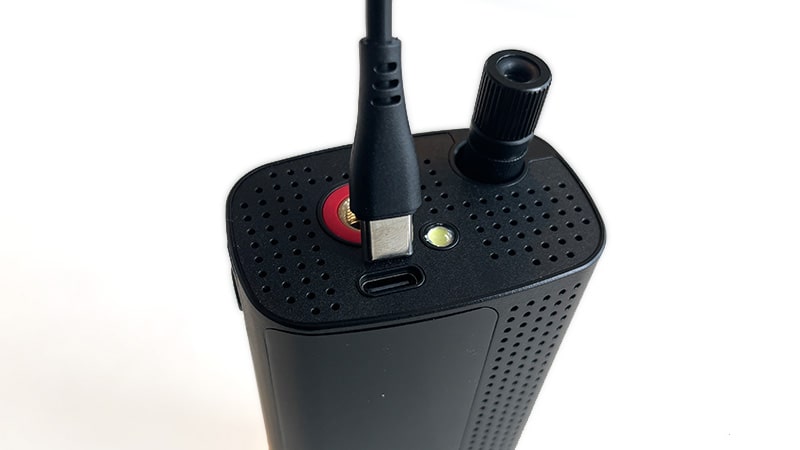 Top of the Airmoto tire inflator with its charging cable and USB-C port
