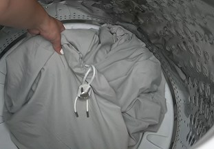 Bed Bunny sheet going into a front-loading washing machine