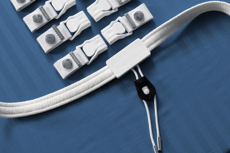 Close-up of the Bed Scrunchie's eight fabric clips, central buckle and parachute-cord drawcord laid out