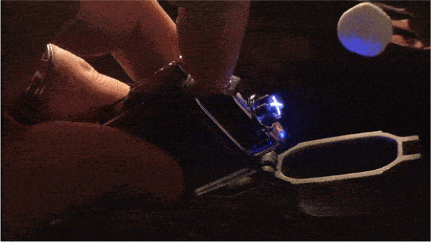 The Black Electric Lighter's built-in LED flashlight switched on in a dark setting