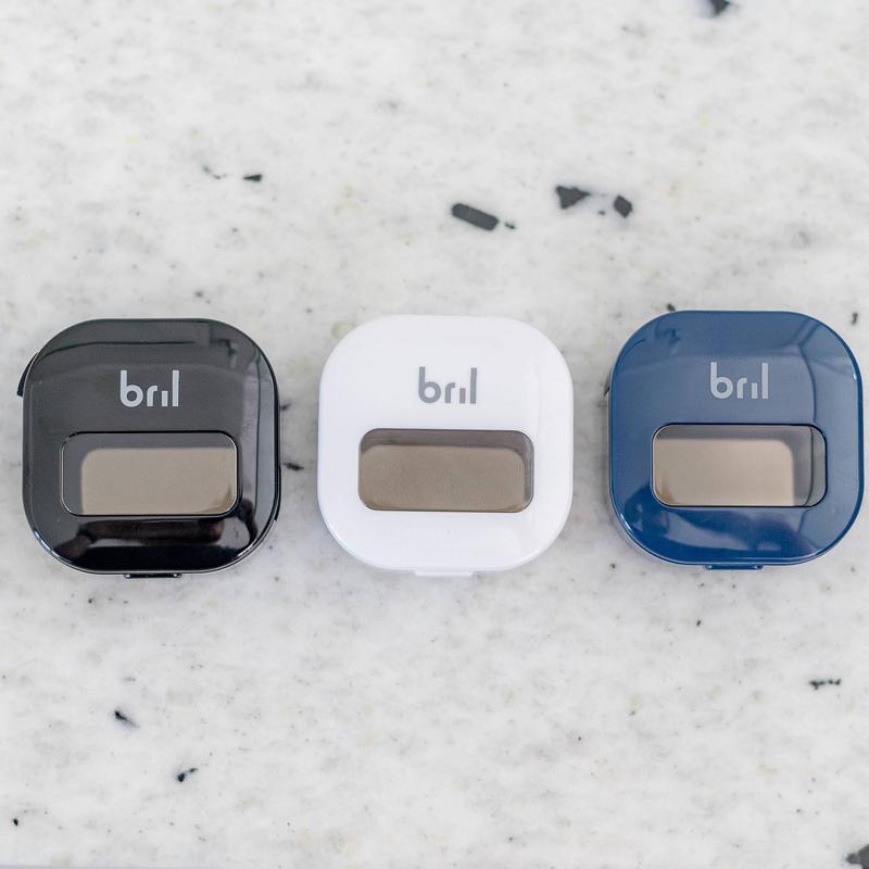 Bril UV-C toothbrush sanitizer in black, white, and navy laid out side by side