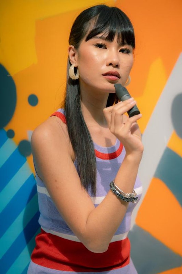 A person holding the Capnos Legura flavored-air device