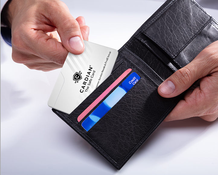Cardian The Safe Card being slid into a leather bifold wallet alongside credit cards