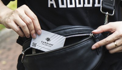 Cardian The Safe Card being slipped into a bag alongside other cards