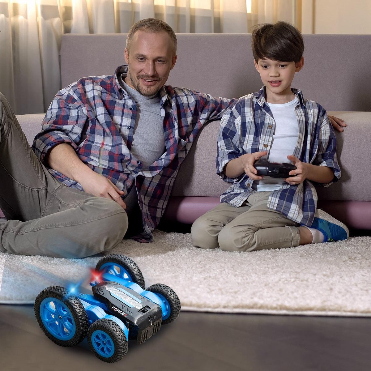 Force1 Tornado LED remote control stunt car on the floor with a father and son playing