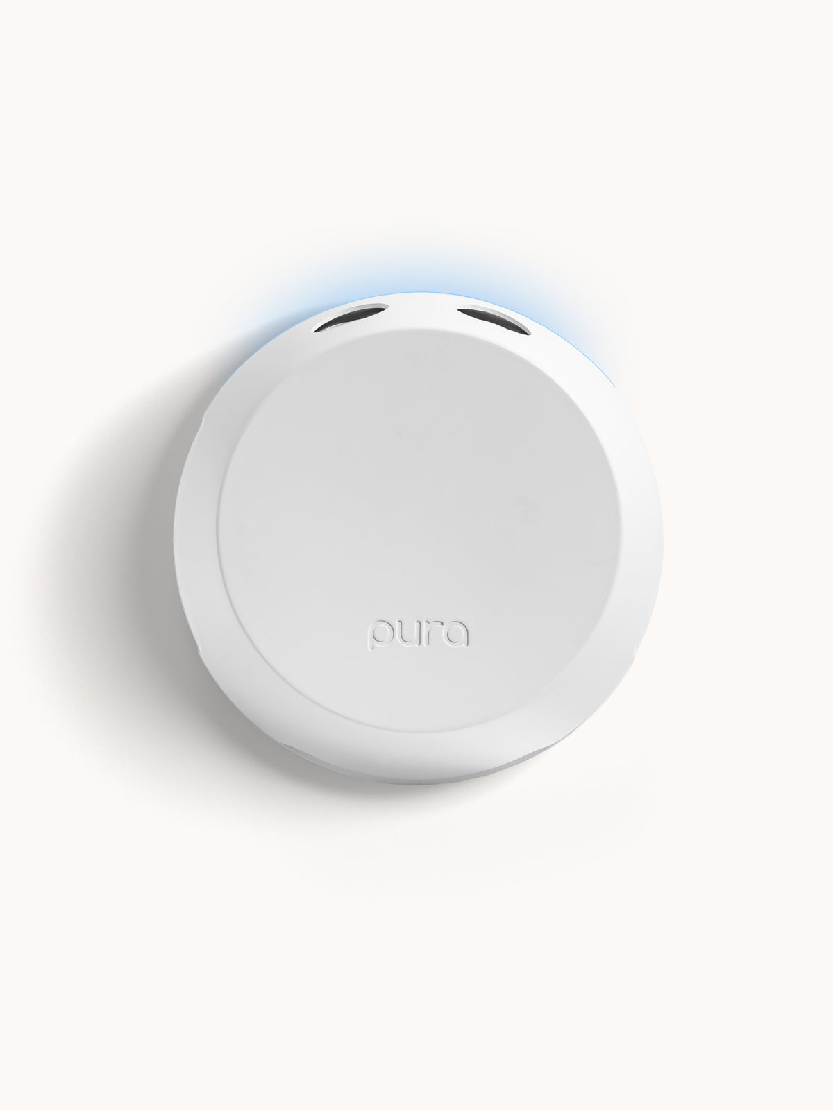 Pura fragrance diffuser in white with a blue accent light