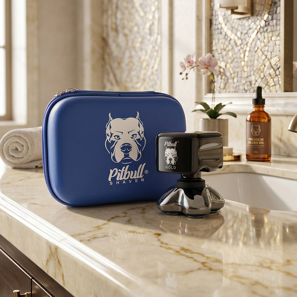 The Skull Shaver Pitbull Gold PRO head shaver and its blue travel case on a bathroom counter