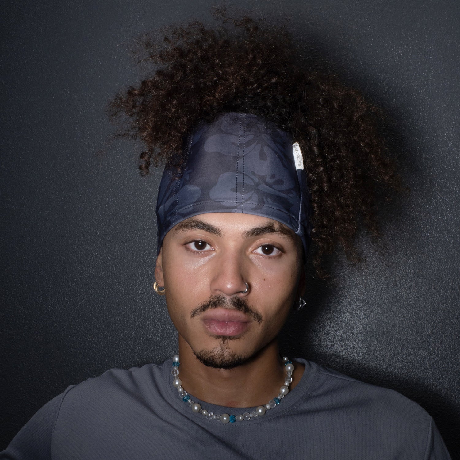 The SkullSkurt migraine headband with removable gel packs worn on the head
