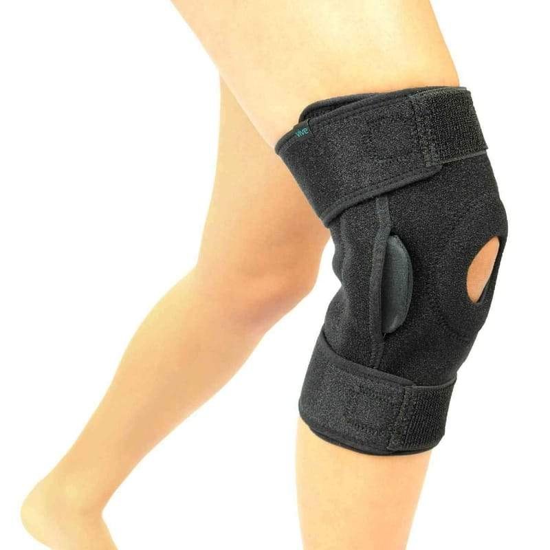 The black Vive hinged knee brace with side hinges and straps worn on a leg