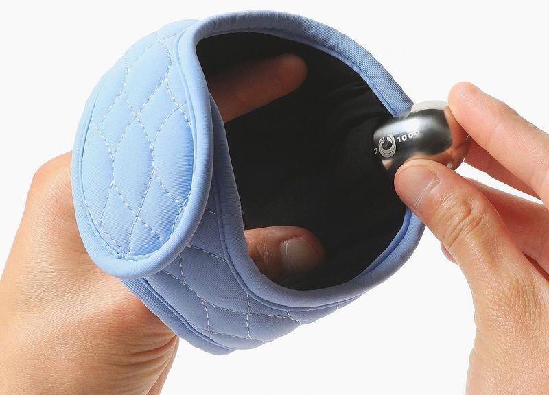Hands inserting the stainless-steel Cool Cura ice pod into the neckband