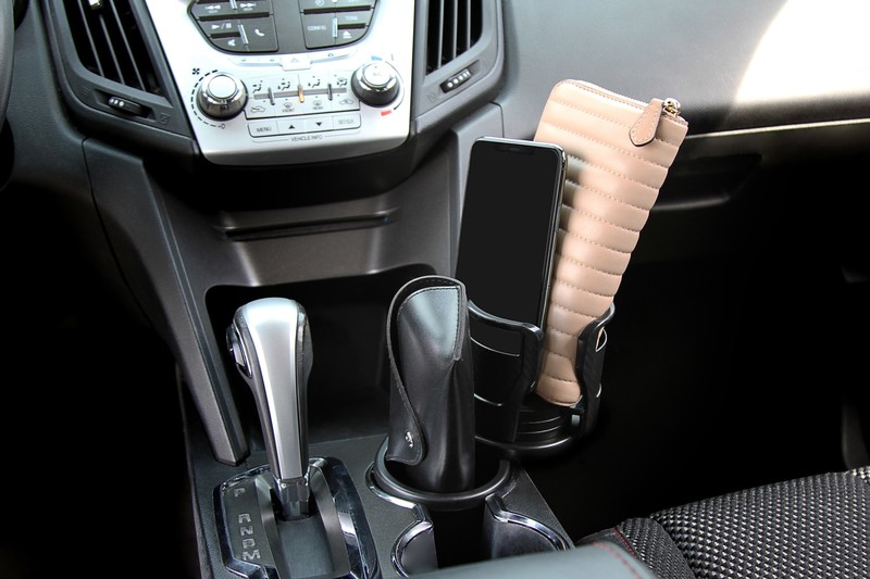 CupStation holding a phone and a wallet in a car center console
