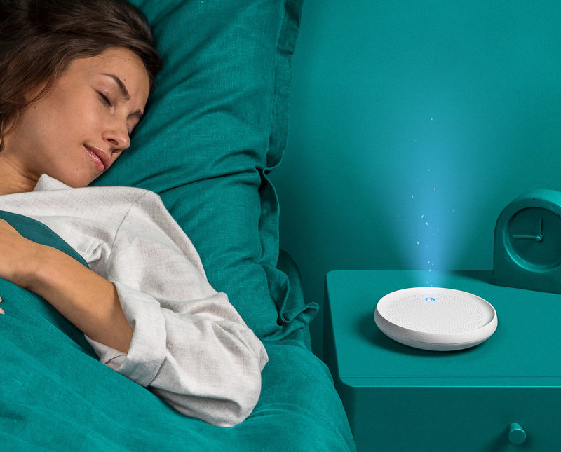 Dodow sleep aid projecting its blue light rhythm onto the ceiling from a nightstand