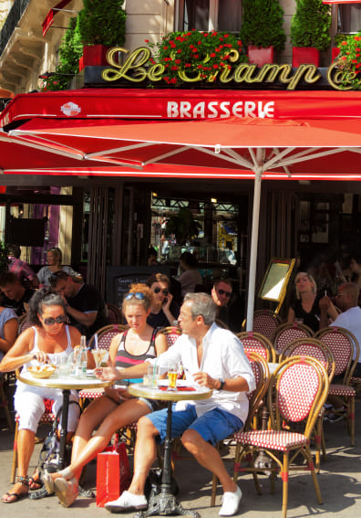 A busy Paris brasserie terrace, the kind of setting where a pocket translator comes in handy for ordering