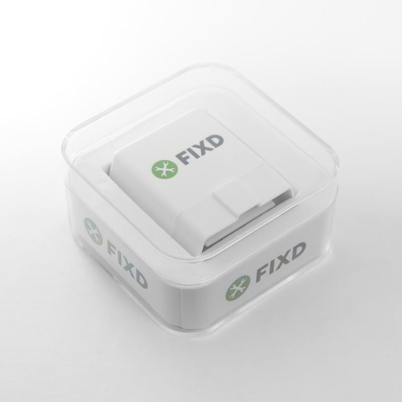 The white FIXD OBD2 sensor sitting in its clear retail case