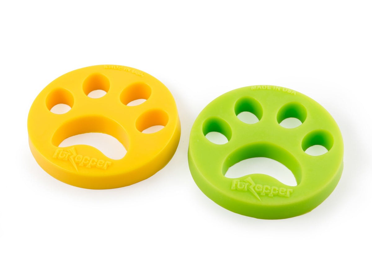 Two FurZapper silicone pet hair remover discs, green and yellow