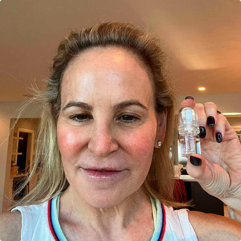 A customer holding the Glamory MicroLift System micro-infusion device