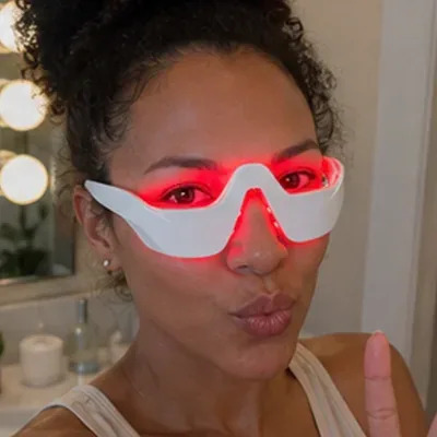Close-up of a woman using the Glokore EyeRenew Pro therapy glasses