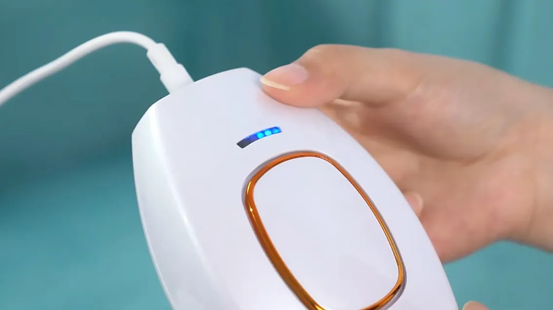 Close-up of the Glokore IPL Hair Remover handset and its power cord