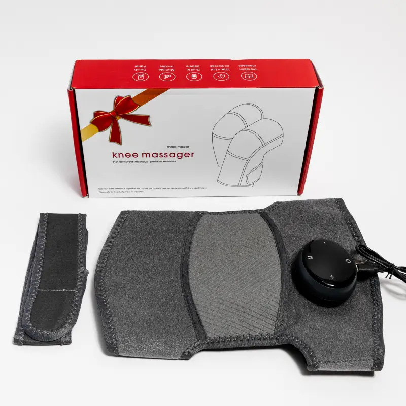 The Glokore Knee Massager wrap and control module shown with its retail box