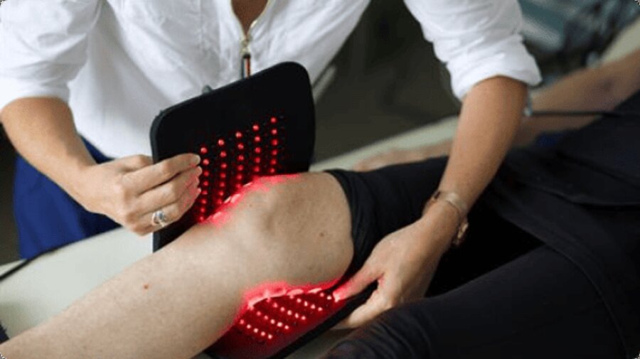 Glokore Red Light Therapy Wrap applied to a knee with its red LEDs lit