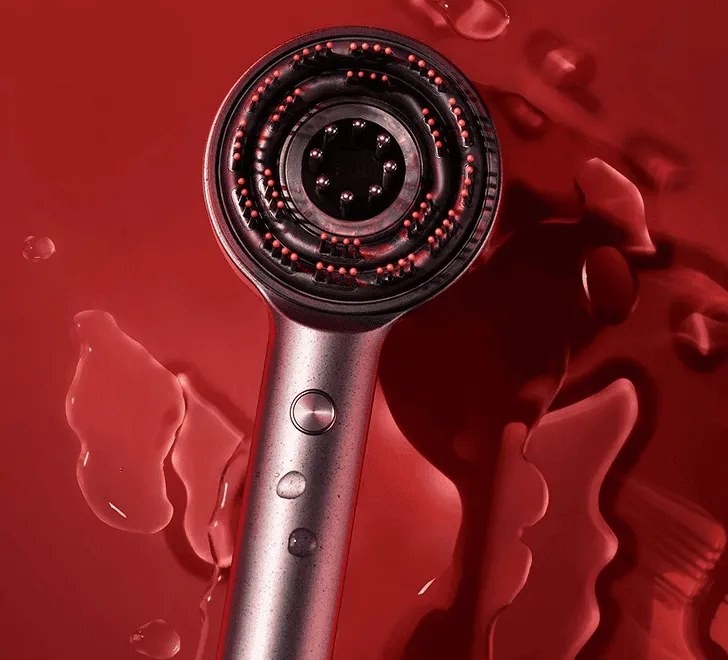 Glokore Scalp Massager head with water droplets, showing its shower-safe design