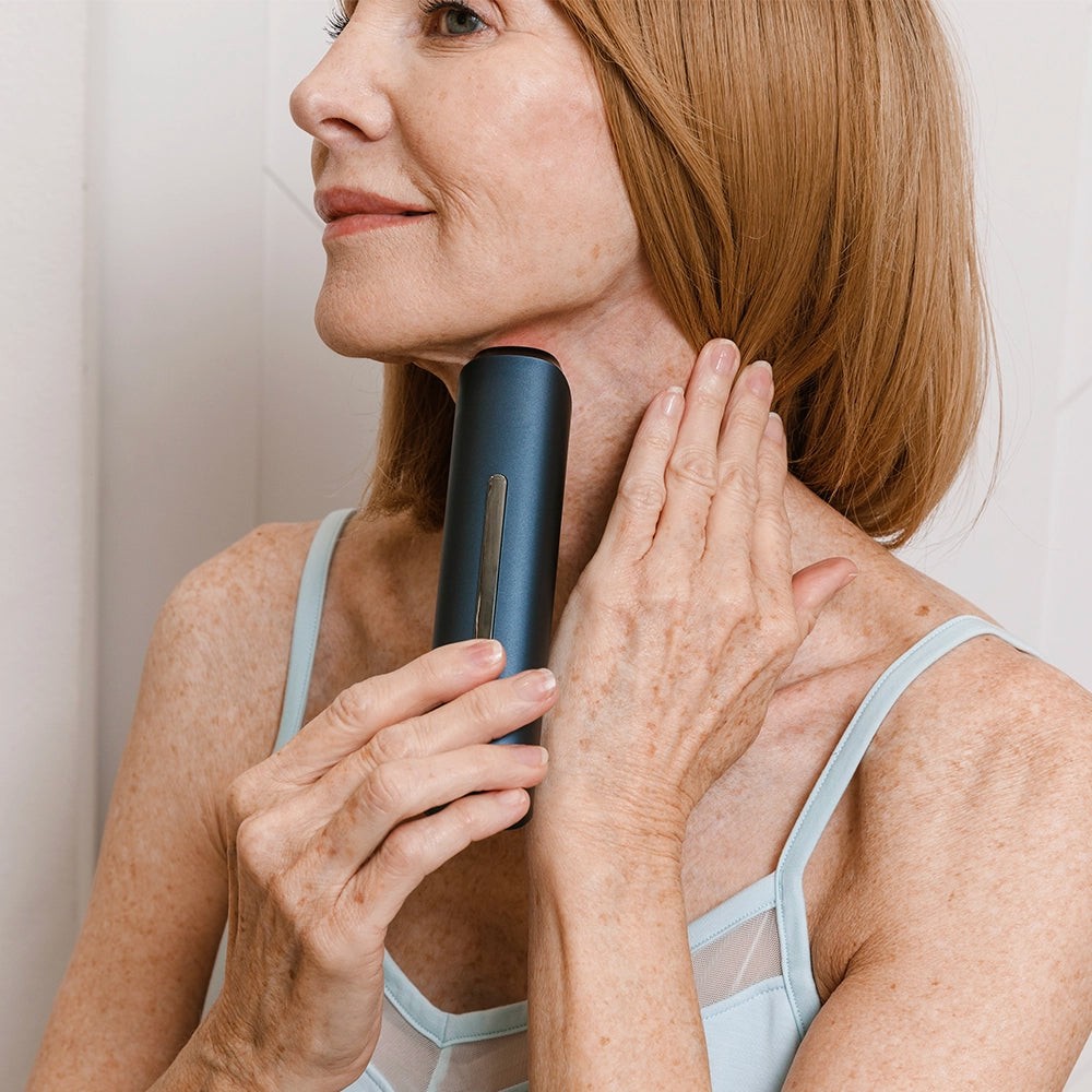 Person gliding the Glokore Transformer Wand along the neck and jawline