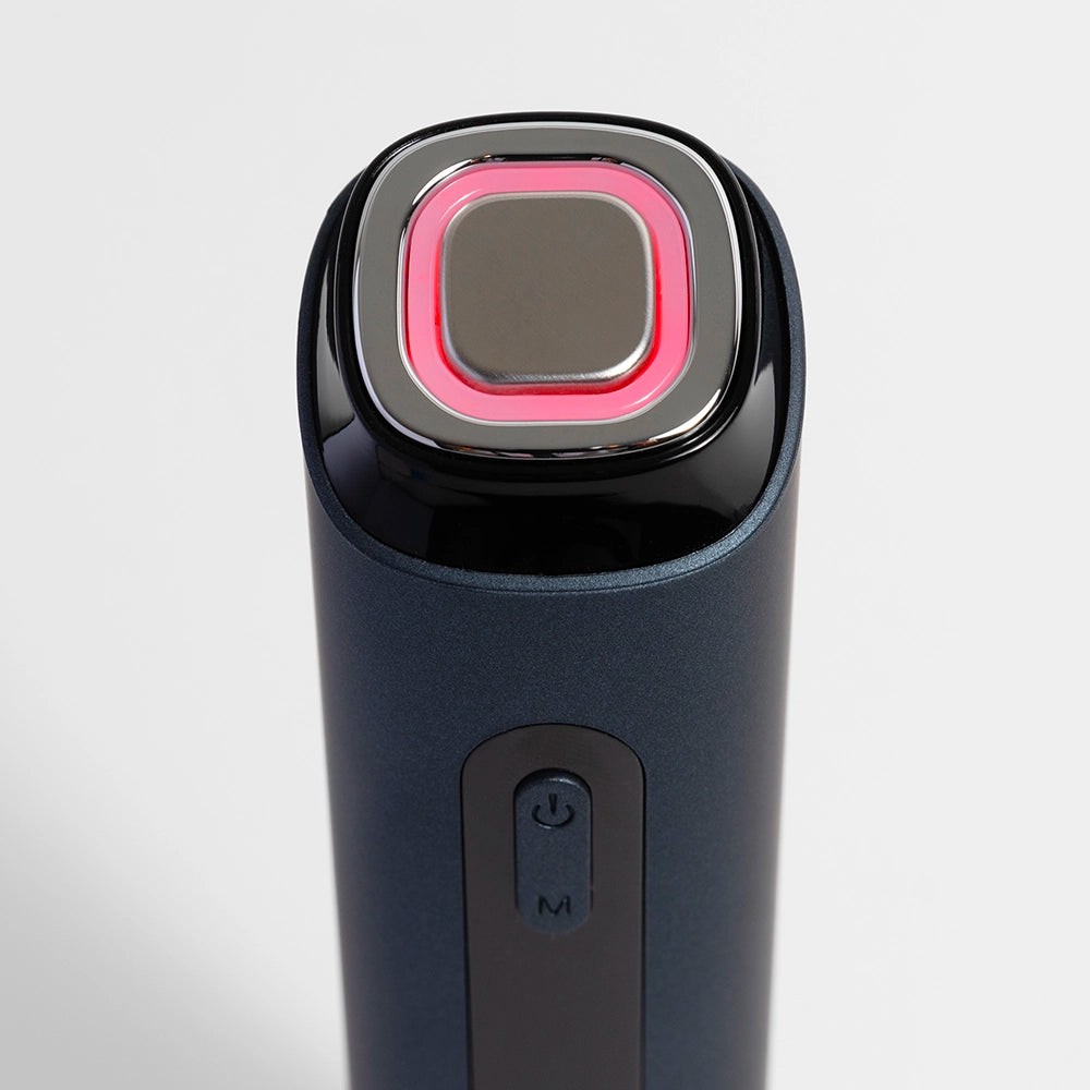 Close-up of the Glokore Transformer Wand tip showing the microcurrent plate and red LED ring