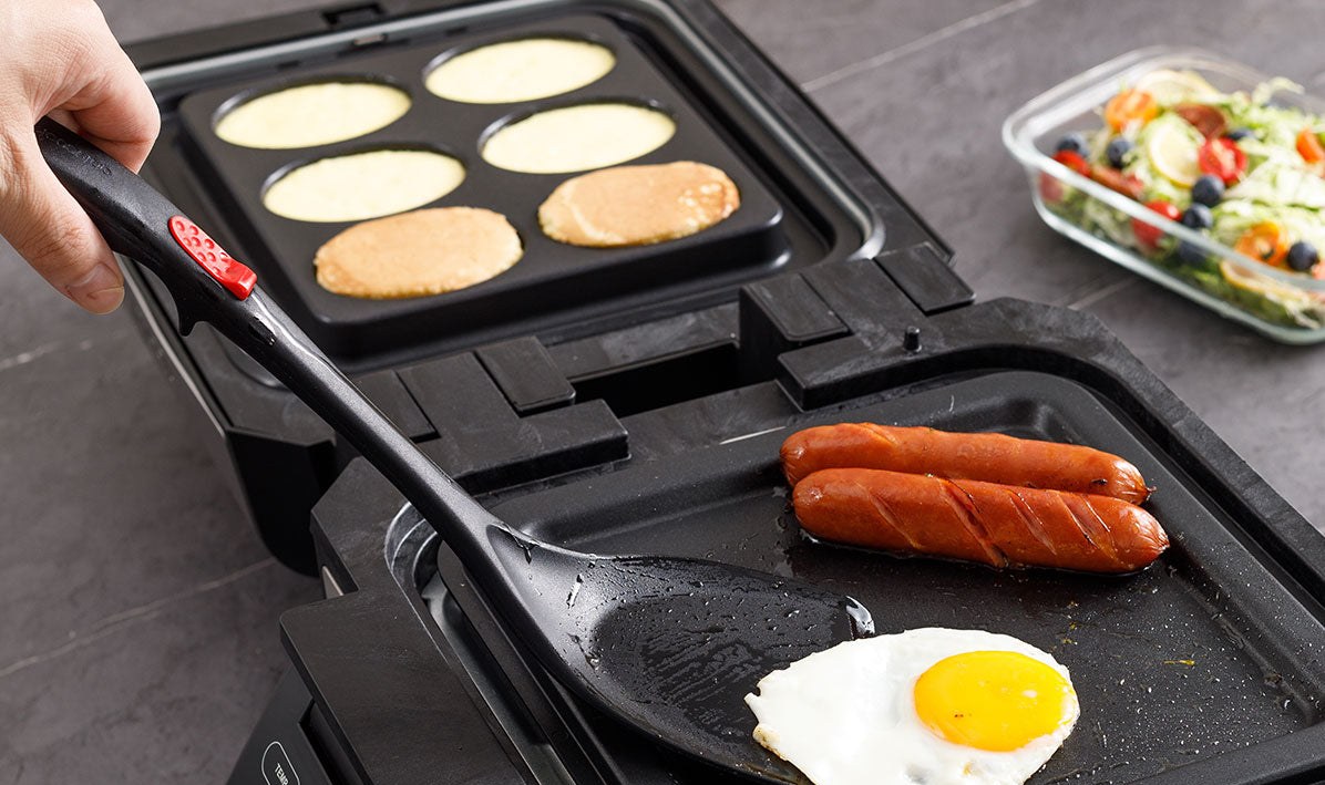 Pancakes, sausages and a fried egg cooking together on the Gourmax Pro's grill and griddle plates