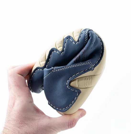 The Grounded Footwear Evolve sole flexed to show its thin, flexible construction