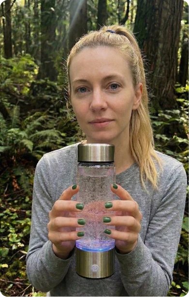 Person drinking from the H2Next hydrogen water bottle outdoors