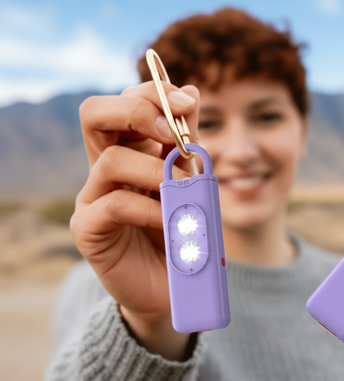 Halo Siren personal safety alarm held in a hand, showing its compact keychain size