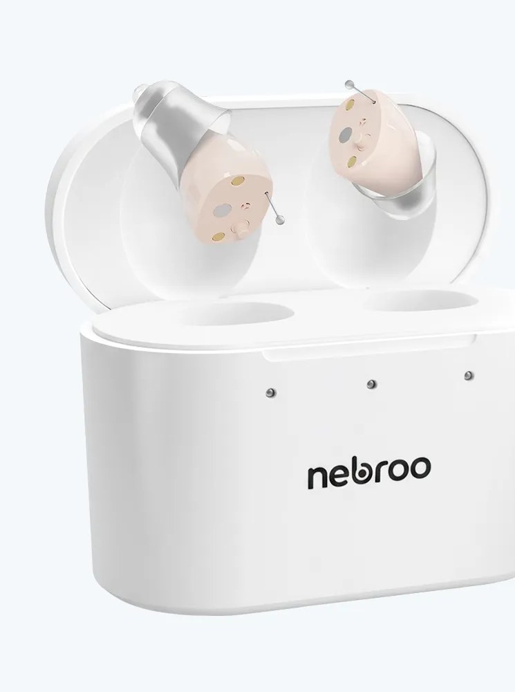 A pair of HearWell in-canal hearing aids resting in their white portable charging case