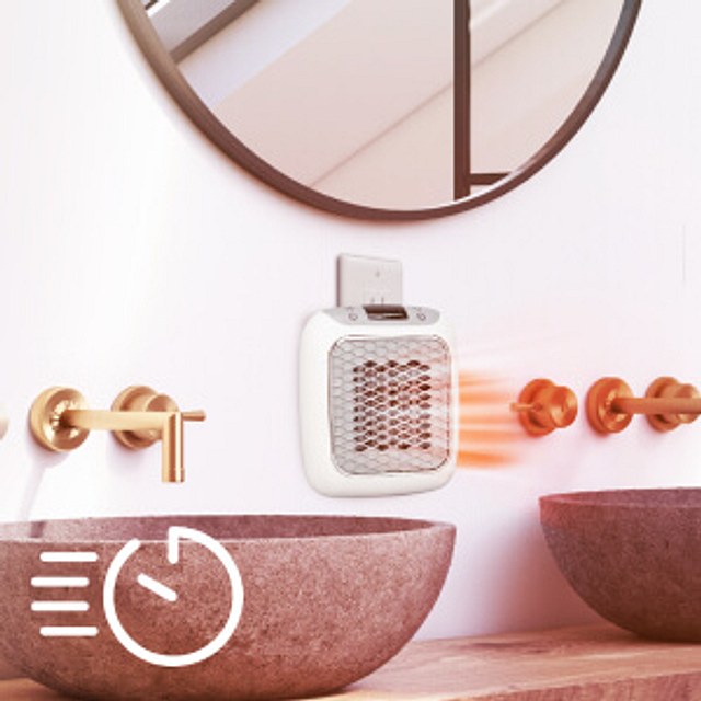 HeatWell ceramic heater plugged into a wall outlet above a bathroom vanity and sink