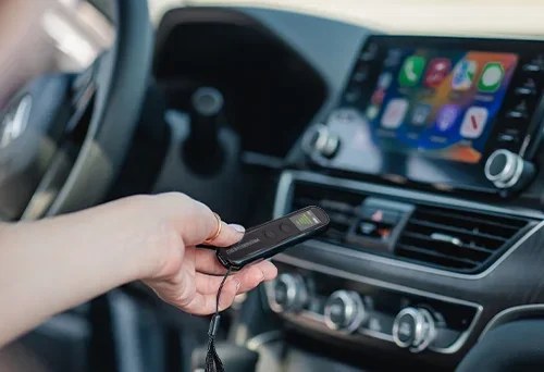 Traveler holding the Hero Privacy Pen inside a rental car to check for GPS trackers