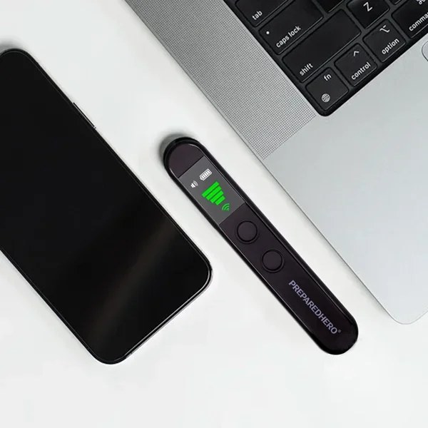 Hero Privacy Pen held next to a laptop and phone on a desk while scanning for wireless signals