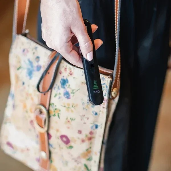 Hero Privacy Pen clipped to a travel bag by its lanyard