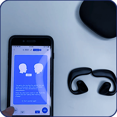 Keilini TalkEase earbuds beside a phone showing the two-way translation app
