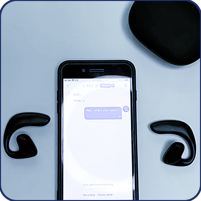 Two Keilini TalkEase earbuds beside a phone running a live translated conversation