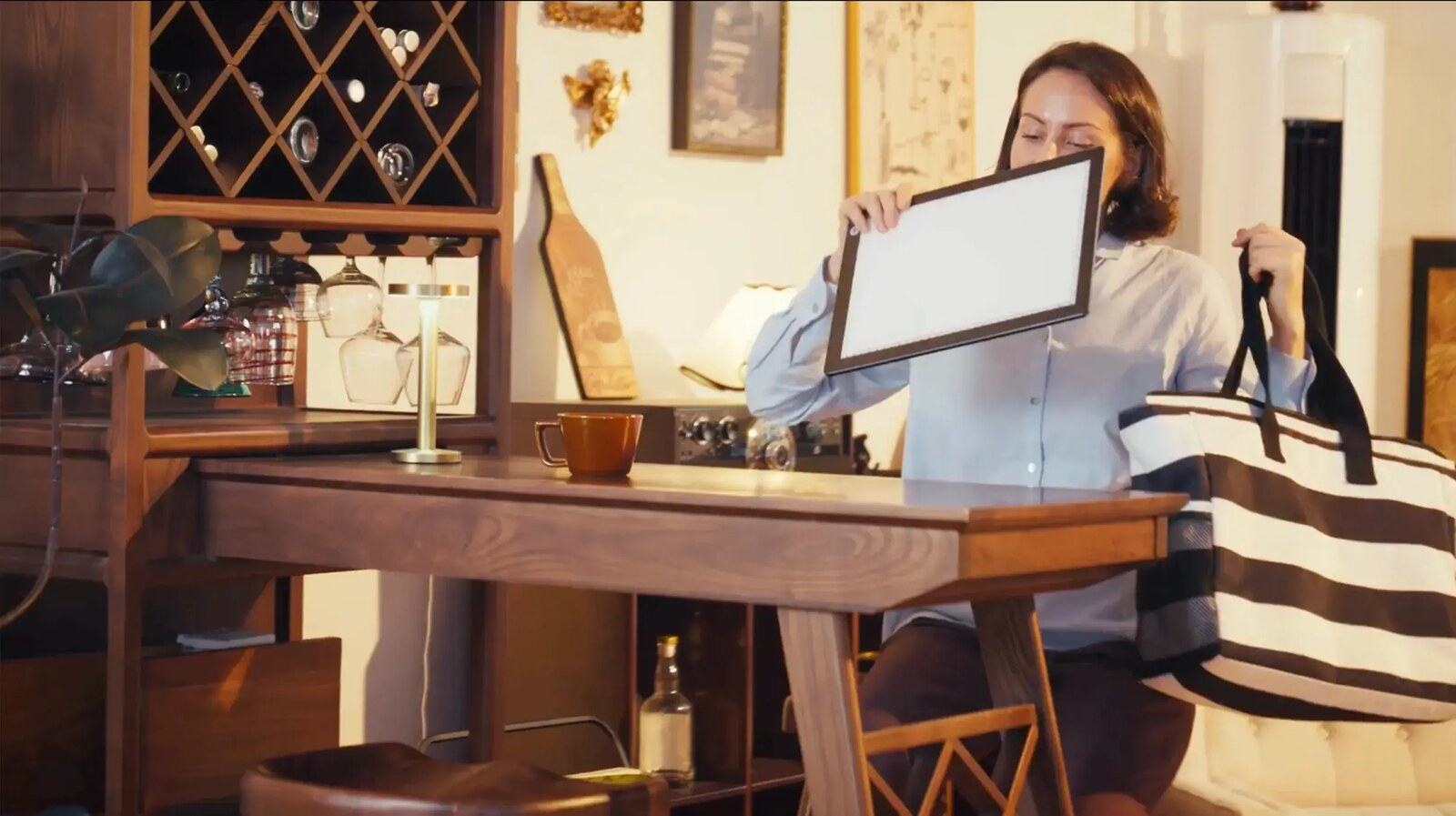 A person slipping the slim Lite Sketch Lightpad into a tote bag