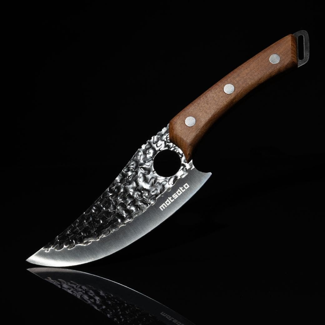 Hammered Matsato chef knife angled on a dark reflective surface