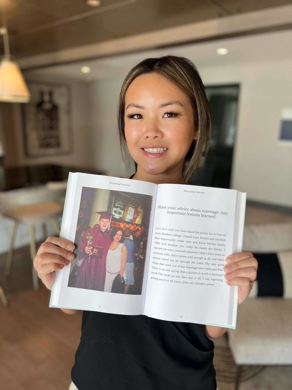 Person holding an open Memorygram legacy book to a marriage-advice prompt page