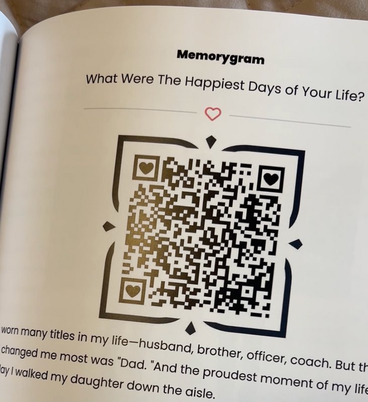 A Memorygram legacy book page with a scannable heart QR code beneath a life-story prompt