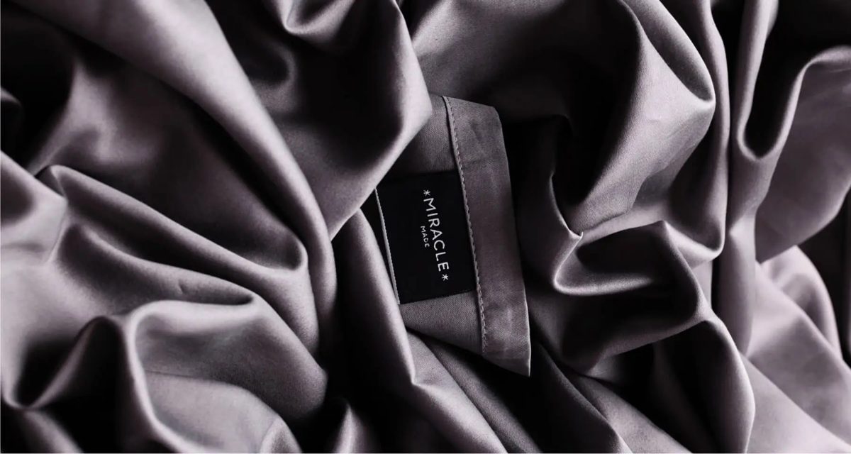 Close-up of the sateen cotton fabric and label on Miracle Made sheets