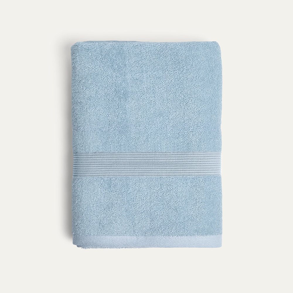 A folded sky-blue Miracle silver-infused bath towel