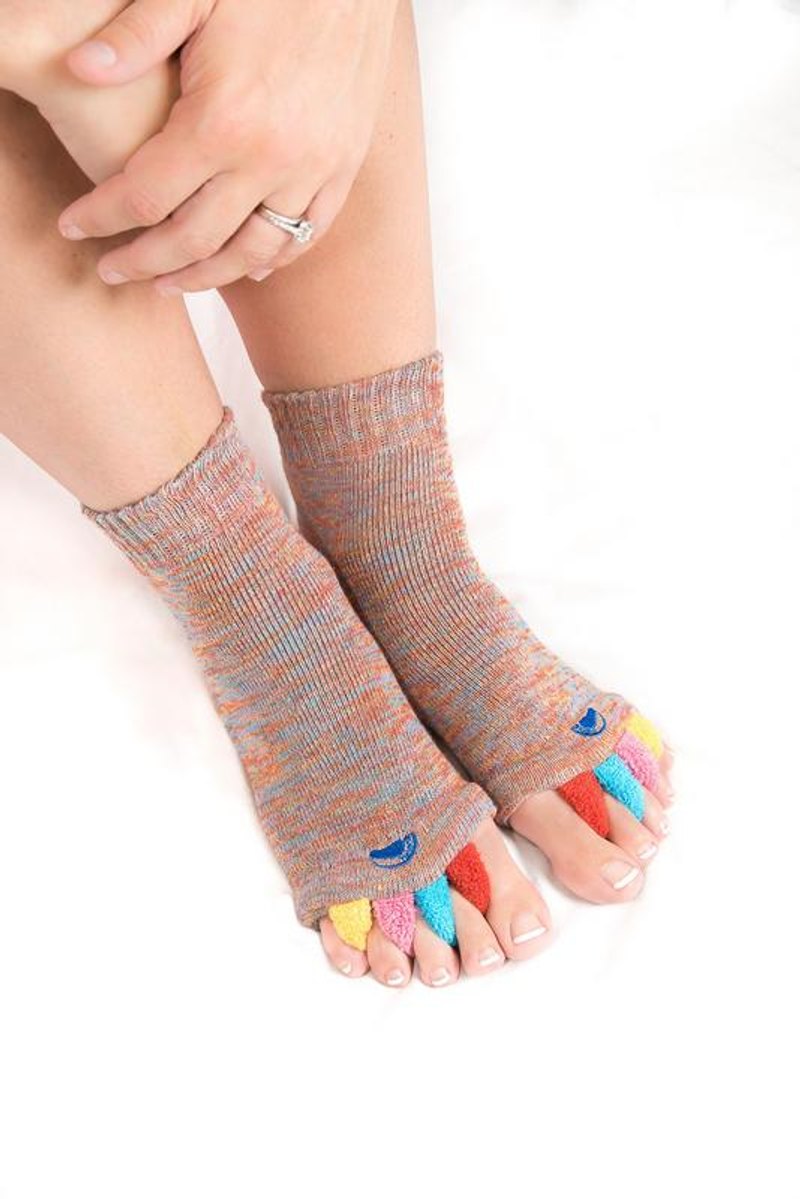 A person sliding on a My Happy Feet foot alignment sock with colorful toe separators