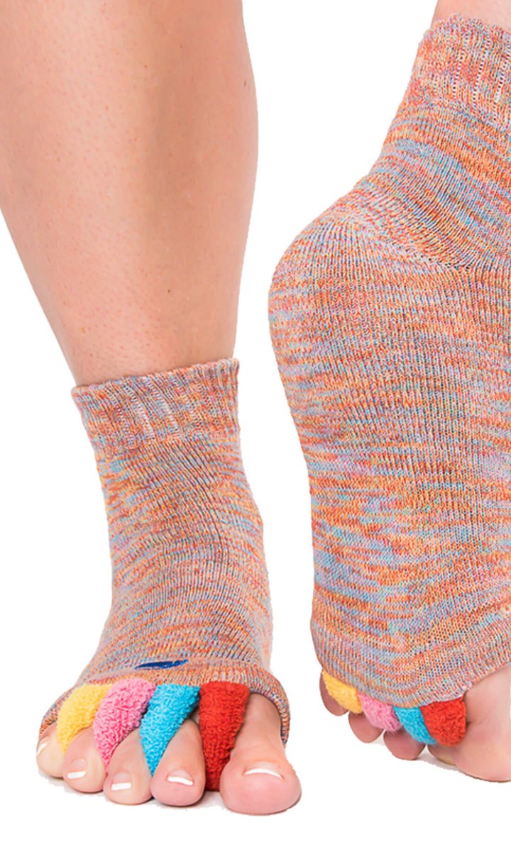 Person standing while wearing My Happy Feet foot alignment socks with toes spread by the separators