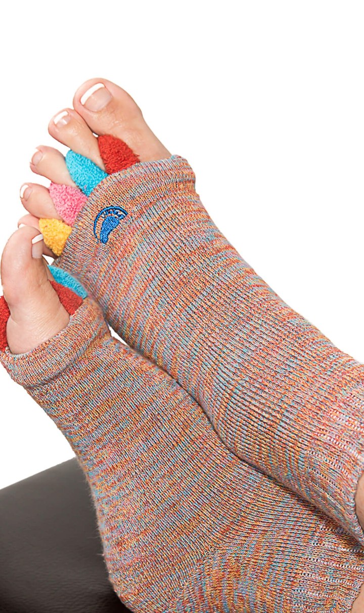 Close-up of a foot wearing My Happy Feet alignment socks with five colorful padded toe separators