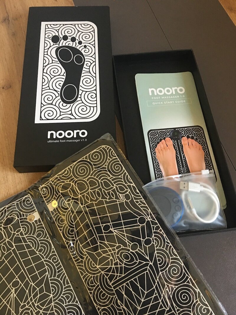 Nooro Foot Massager kit unboxed: the mat, magnetic controller, USB-C cable and quick start guide