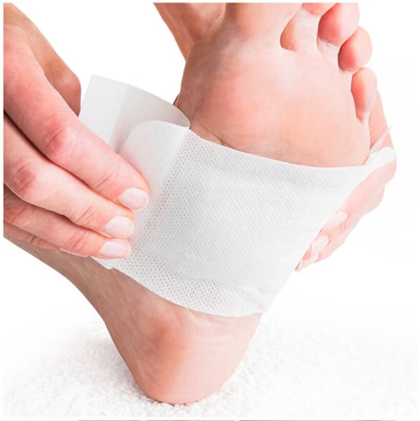 A Nuubu foot pad pressed onto the sole of a foot before bed